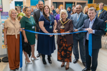 People cutting a ribbon to open a new health, wellbeing and education hub