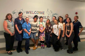 Staff and students in front of the new maternity mural at Warrington Hospital 