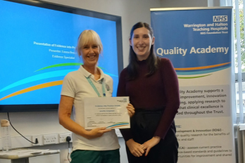 Photo of Janette Singleton, Occupational Therapy Clinical Lead, pictured receiving the WHH Evidence into Practice Award from Emma Brown, Evidence Specialist